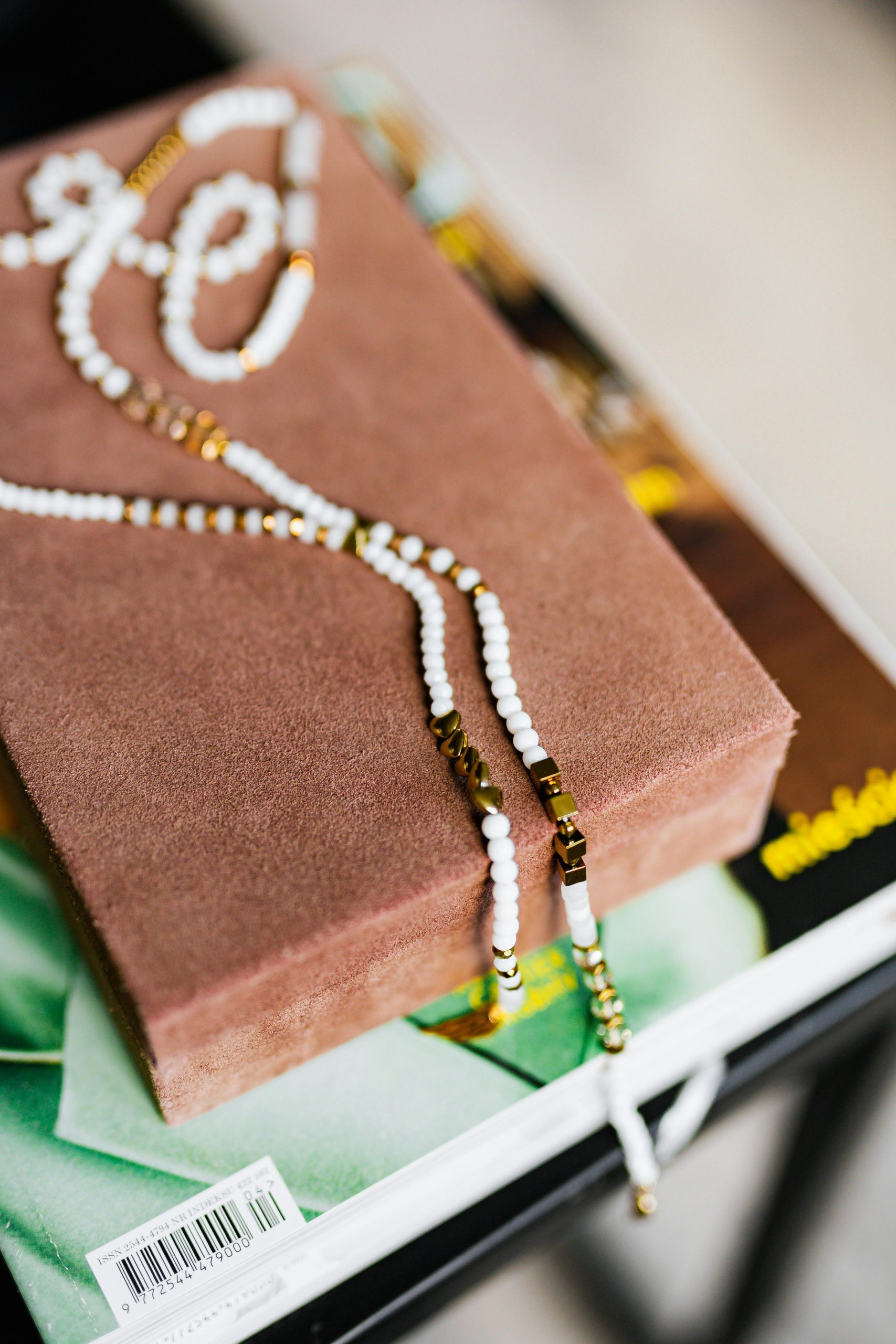 Close-up of beaded necklace on a soft velvet box, stylish and luxurious.